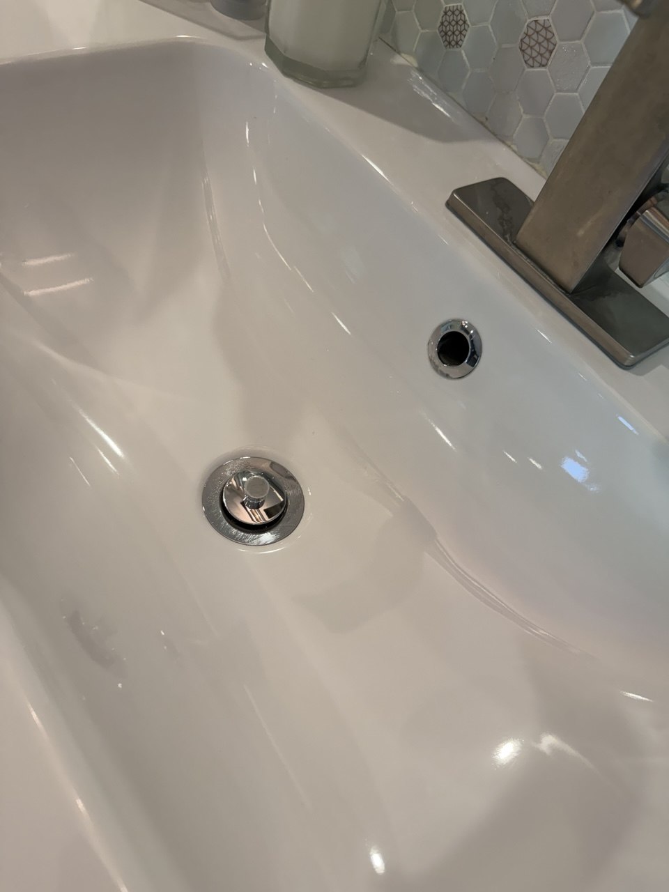 The same bathroom sink after cleaning, spotless and polished